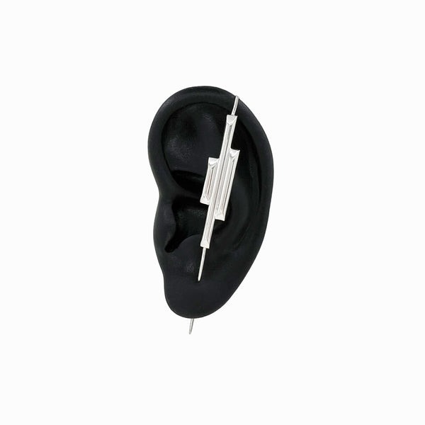 Handcrafted sterling silver Basalt Ear Pin by Elke Van Dyke, featuring sleek, nature-inspired design with textured details.