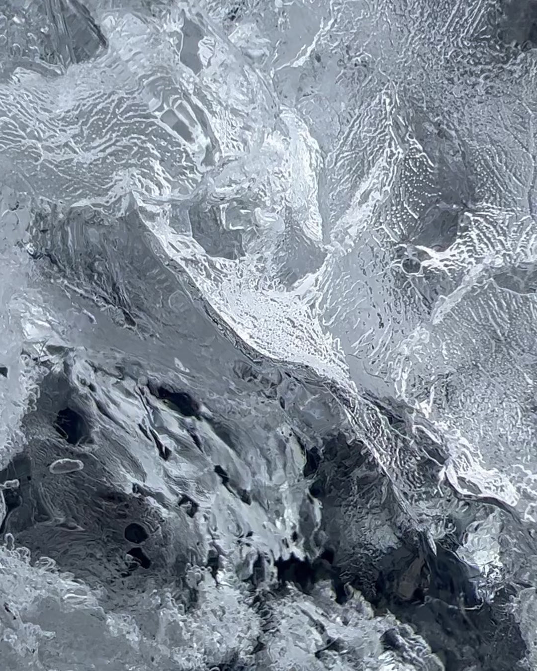 Video of Sterling silver Basalt Earrings by Elke Van Dyke, inspired by Iceland's basalt columns. Handcrafted statement jewelry. Displayed on ice.