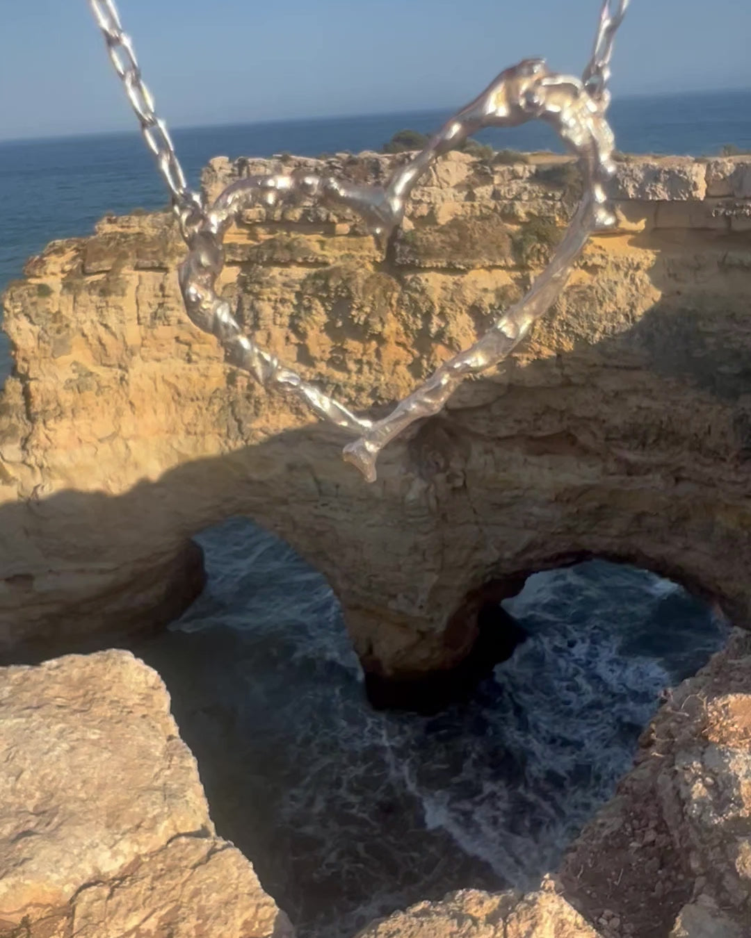 Video of Algarve Heart Necklace handcrafted in sterling silver, inspired by Portugal's Algarve coastline. Bold, sculptural design by Elke Van Dyke.