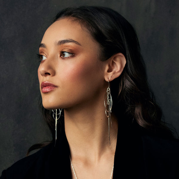 Gold Orbit Chain Earrings with flowing dangle design—handmade minimalist statement jewelry by Elke Van Dyke.