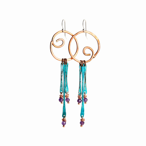 Dos Olas Earrings—handcrafted copper and silver with faceted amethyst and turquoise patina. Sculptural movement by Elke Van Dyke.