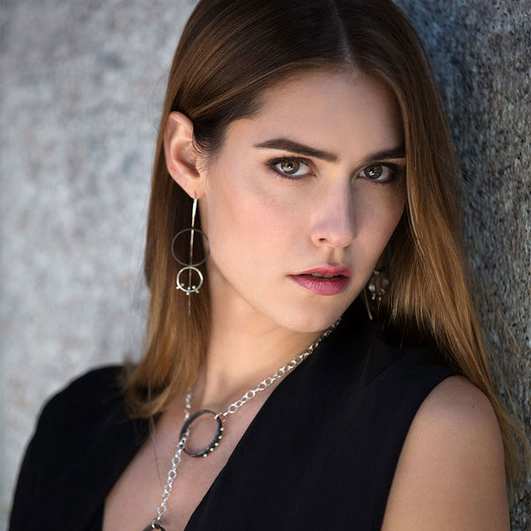 Two-tone Lunar Eclipse Earrings—sculptural moons in oxidized and polished sterling silver, evoking a celestial eclipse by Elke Van Dyke.