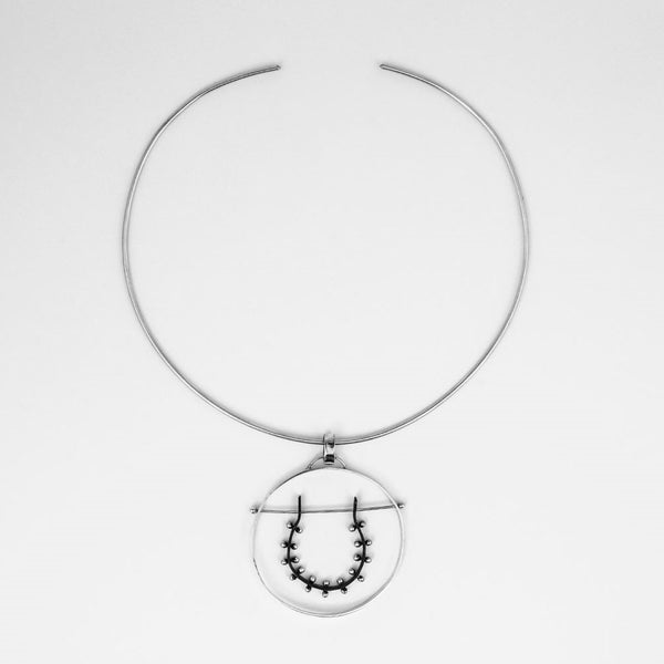 Moonscape Horseshoe Pendant Necklace o model. Oxidized and polished sterling silver, sculptural moon-inspired design by Elke Van Dyke.