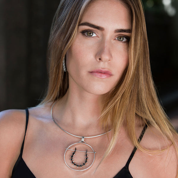 Moonscape Horseshoe Pendant Necklace o model. Oxidized and polished sterling silver, sculptural moon-inspired design by Elke Van Dyke.