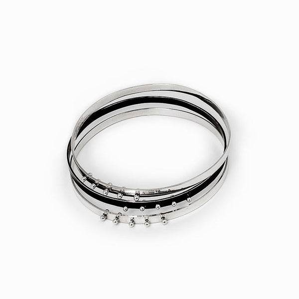 Moonscape silver bangle bracelet—high-polish and oxidized sterling silver, sold as single or set of 3. Sculptural two-tone design by Elke Van Dyke.