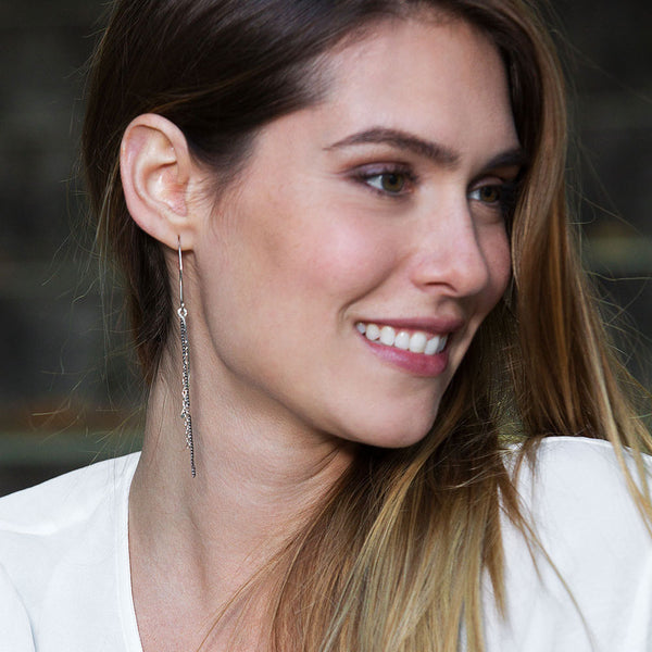 Ripple Waterfall Earrings with cascading chain design. Handmade in sterling silver with sculptural, lightweight movement by Elke Van Dyke.