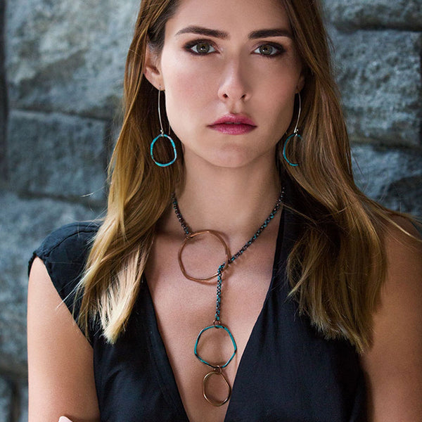 Sea Stone Necklace on model—sculptural Y-style lariat in handcrafted patina copper. A poetic ocean-inspired design from the Seascape Collection by Elke Van Dyke.