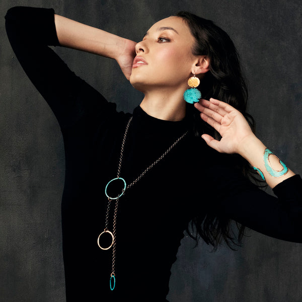 Deep Swell Earrings—handcrafted copper and silver with turquoise patina. Sculptural interpretation of water’s movement by Elke Van Dyke.