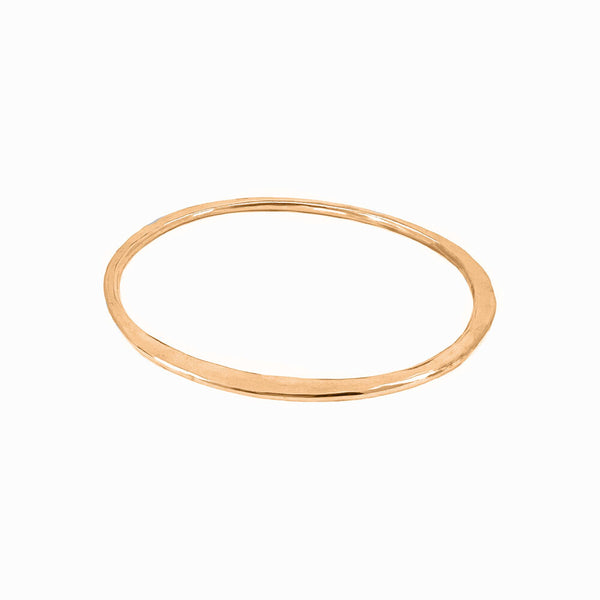 Gold Orbit bangle bracelet, sculptural and handcrafted for solo or stackable wear. By Elke Van Dyke.