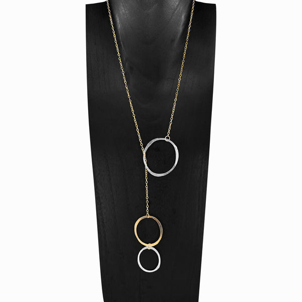 A two-toned necklace featuring a series of connected silver and gold circles, displayed on a black mannequin.