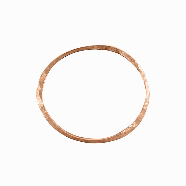 Rose gold Orbit bangle with sculptural elegance—hand-formed bracelet to wear solo or stack and elevate your look by Elke Van Dyke.