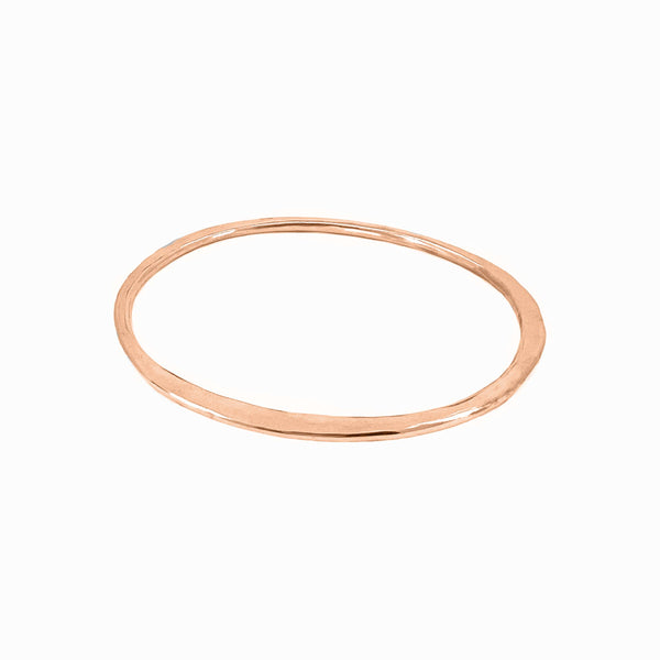 Rose gold Orbit bangle with sculptural elegance—hand-formed bracelet to wear solo or stack and elevate your look by Elke Van Dyke.