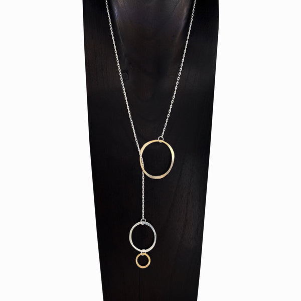 Trio Orbit lariat necklace with sterling silver chain and gold + silver mixed-metal rings—sculptural and lightweight by Elke Van Dyke.