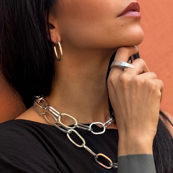 Sacred Bond Earrings—handcrafted in polished sterling silver with bold sculptural chain-link design by Elke Van Dyke.