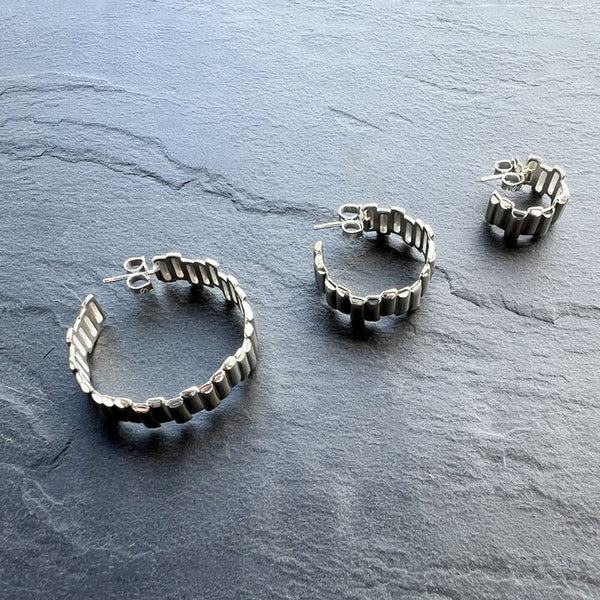 Small Basalt Hoop Earrings by Elke Van Dyke. Handcrafted sterling silver inspired by Iceland’s basalt columns in a petite sculptural scale.