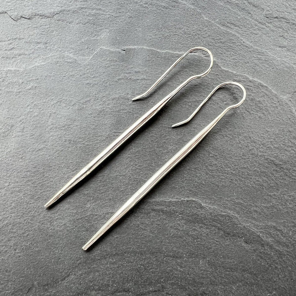 Icicle Earrings—handcrafted sterling silver sculptural drop earrings with sleek winter-light shine by Elke Van Dyke.