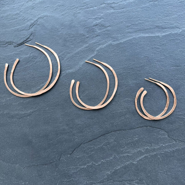 Rose Gold Orbit Hoop Earrings by Elke Van Dyke are 14K gold fill sculptural hoops with undulating form. Available in 3 sizes.