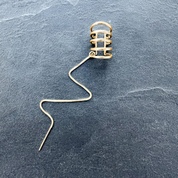 Gold Quint Ear Cuff with Chain Thread by Elke Van Dyke—handcrafted s14K over terling silver with a sleek cascading chain. Eevate your ear stack.
