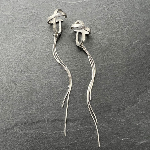 X-Nova Ear Cuff—sculptural sterling silver cuff with long cascading chain and celestial sheen. Statement wearable art by Elke Van Dyke.