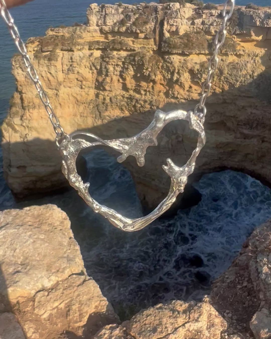 Video of Portugal Heart Necklace handcrafted in sterling silver, inspired by Portugal's Algarve coastline. Bold, sculptural design by Elke Van Dyke.