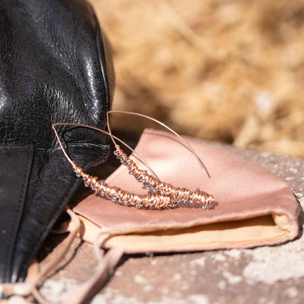 Elke Van Dyke Design Gold Cocoon Threader Earrings laying on ground detail view